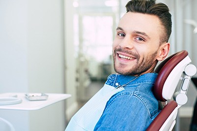 Patient smiling while sitting in treatment chair