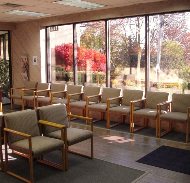 Waiting area with colorful autumn trees outside of the window