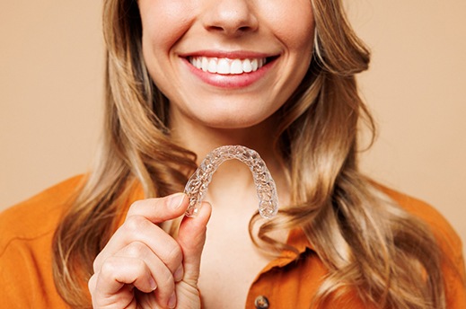 a patient holding their Spark clear aligner