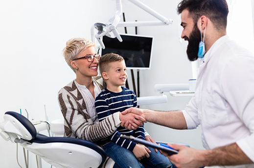 Woman shaking hands with her childs orthodontist