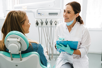 Orthodontist with a clipboard listening to a patient