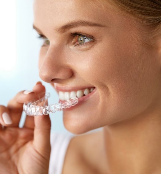woman trying on clear aligners