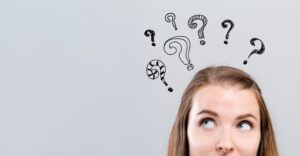 Top of woman's head with question marks floating above her